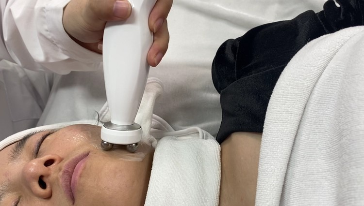 cold plasma handpiece working across the neck during a client session